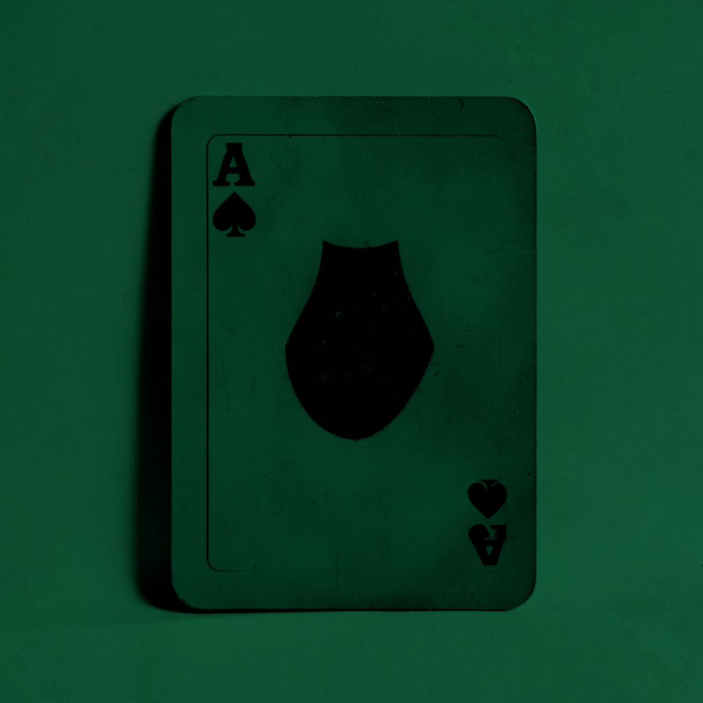 Hard two-tone duotone in dark green and black showing a single joker card